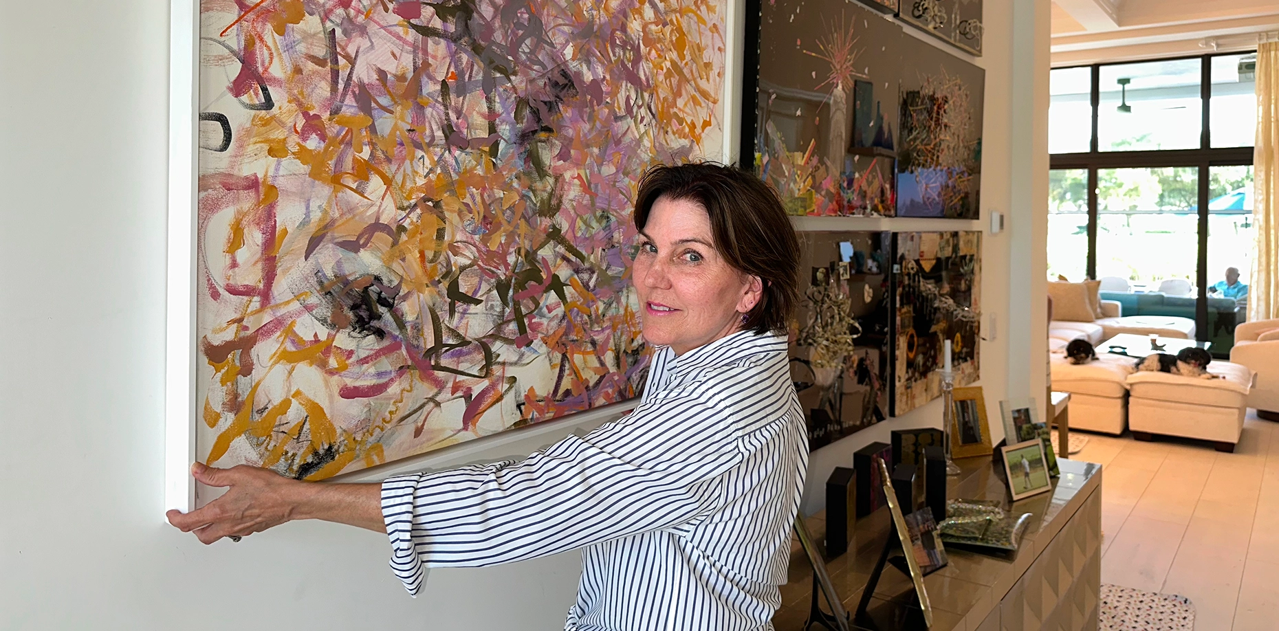 Person arranging art in modern living room