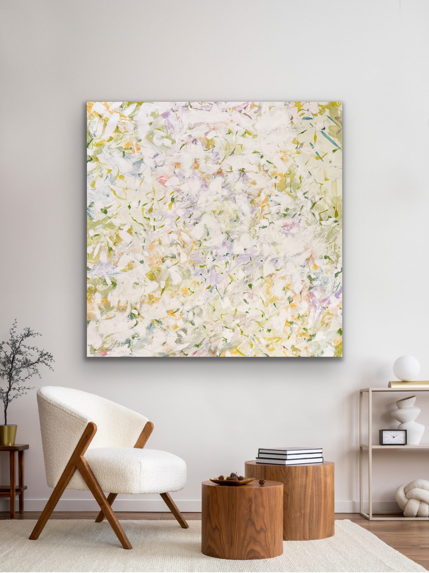 Abstract floral painting with soft pastel colors hanging on a wall.